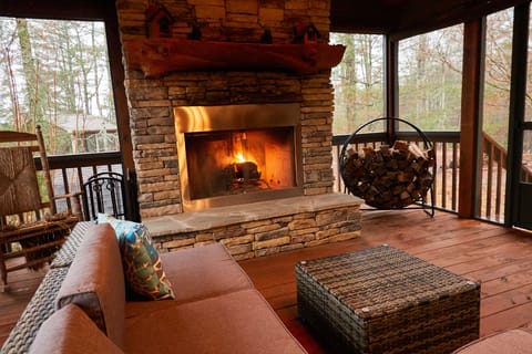 Fully screened in Outdoor side patio with wood burning Fireplace (non propane)