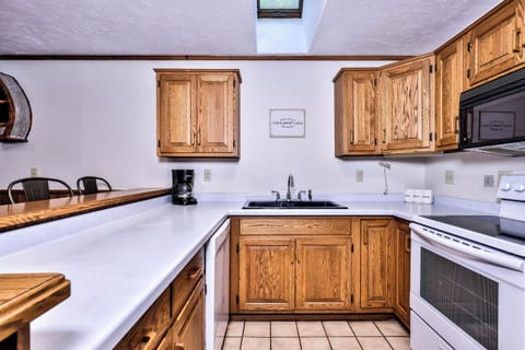 Fully stocked kitchen with glassware, cookware, utensils, coffee maker and more.