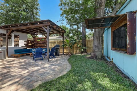 The backyard lounge area with mounted outdoor TV.