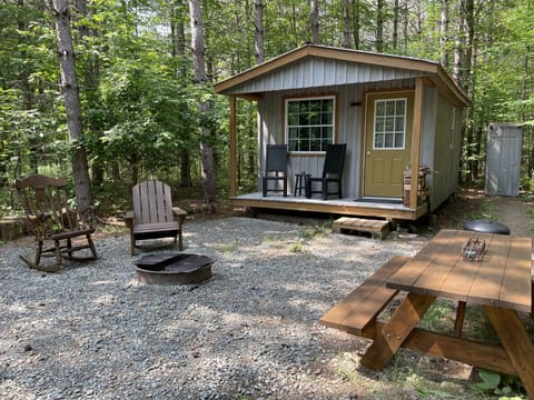 One bedroom cabin nestled on wooded private acre.
