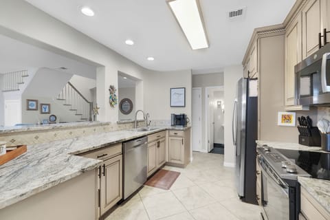 Totally Renovated Kitchen with Granite Countertops and Stainless Steel Appliances - Kitchen is Open to Living and Dining Spaces