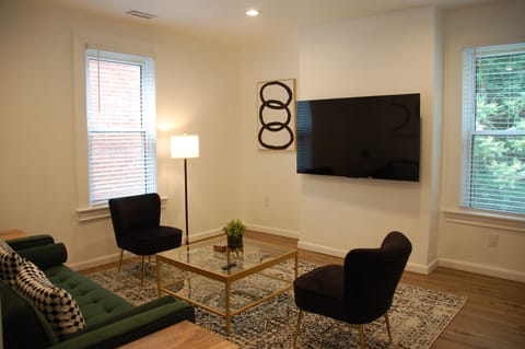 Living room with 65" HDTV - stylish layout with plenty of natural light