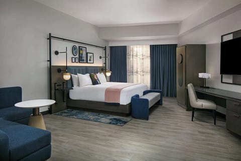 Recharge in a serene king space with dedicated work desk.