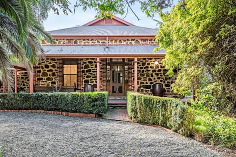 The house presents a majestic exterior, with grand architectural details, elegant lines, and a commanding presence. Surrounded by manicured landscaping and framed by natural beauty, its stately facade and timeless charm make a stunning first impression.