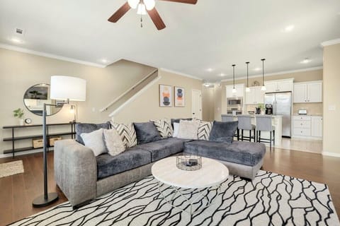 Our bright, open concept living room has a large, ultra-comfy gray sectional, 55-inch Roku TV, working gas fireplace and gorgeous modern flair.