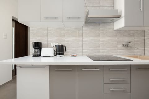 The kitchen counter area with a coffee machine, kettle, and other essentials for a convenient stay.
