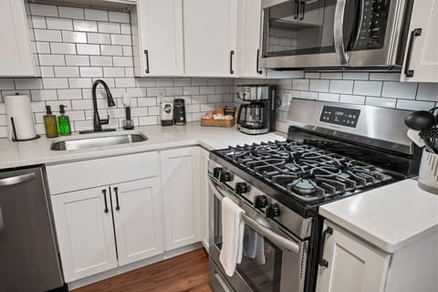 Kitchen with SS Appliances, Gas stove, stocked with dinnerware, cookware, bakeware etc