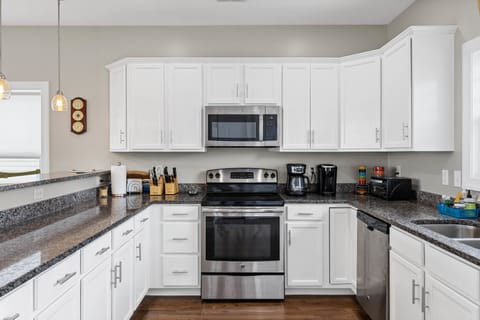 The well-stocked kitchen with countertop seating for 3