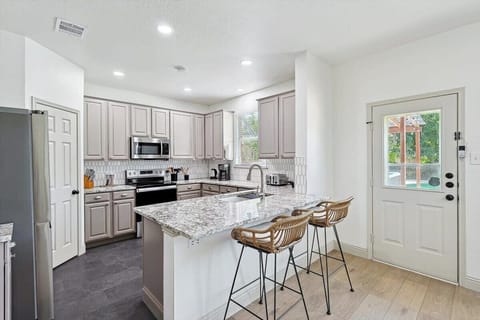 This fully equipped kitchen’s spacious counters offer ample prep space while the breakfast bar and open-concept layout mean you can chit-chat all through dinner prep!