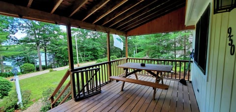 Oversized front porch with large picnic table, grill and lake view.