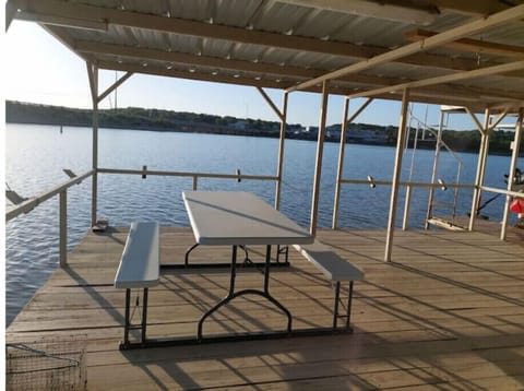 Boat dock  with fish pole holders, dining table and a ladder to access water
