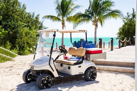 Golf cart that can be driven to the beach nearby Hakuna Matata. The trunk can easily carry beach amenities provided by the villa.