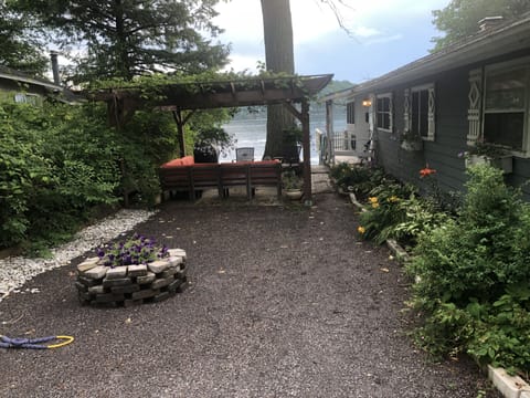 Outdoor patio w lighted pergola, gas grill, hammock, couch and fire pit