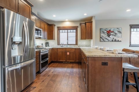 Designed for gathering and ease, this fully equipped kitchen offers generous prep space, modern appliances, and seamless flow into dining and living areas.