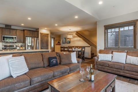 The open-concept layout at Triple Black keeps everyone together — relax by the fire while meals and conversations flow easily between kitchen and dining.