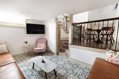 Kick back on the sofa with TV and patterned tile floors.