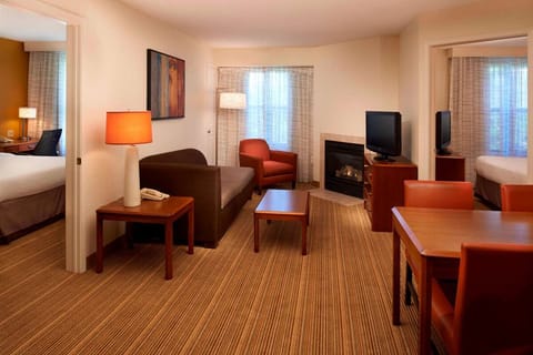 Unwind in the spacious suite with fireplace warmth and seating.