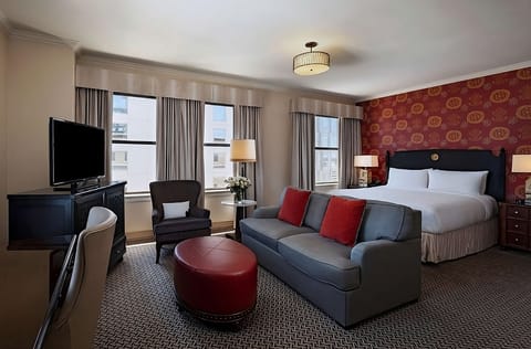 Unwind in a spacious suite with sofa and sunny windows.