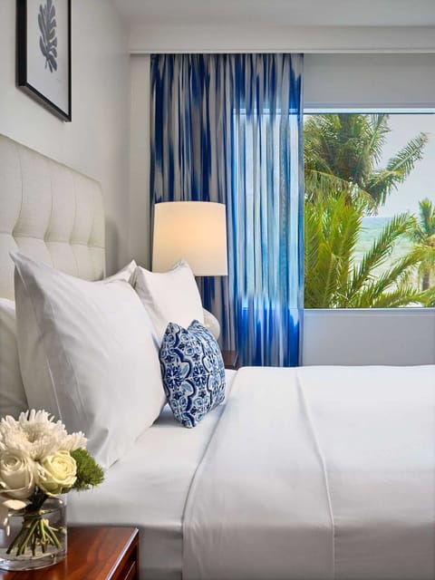 Savor morning calm as palm-framed views brighten the bed.