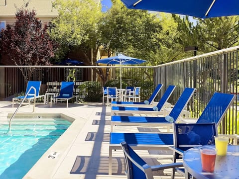 Soak up sunshine on vibrant loungers beside the sparkling pool.
