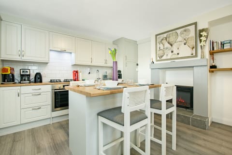 Cozy meals and morning chats come easy with a fireplace right in the kitchen.