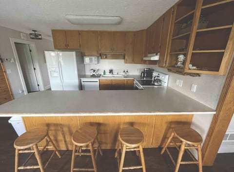 Four bar stools in addition to dining room table that seats six