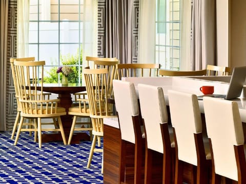 Sip coffee by sunny windows in a cheerful dining area.