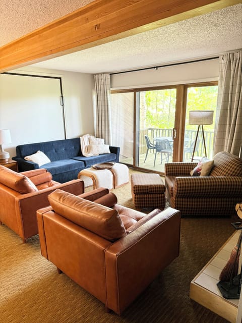 Living space with plenty of comfortable seating, wood fireplace, TV and games.