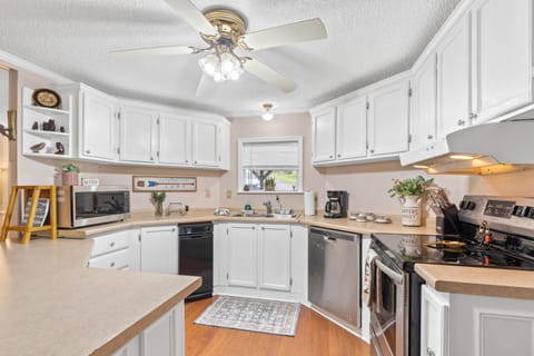 Large open kitchen with SS appliances.