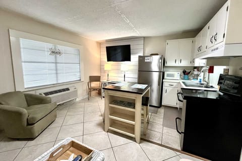 The TV next to the kitchen.dining area.