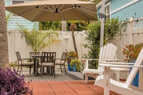 Relax under the umbrella while cooling off with the misting system provided all around the fenced area