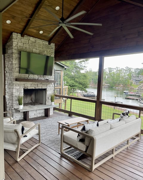 Covered back porch overlooking the pool and lake