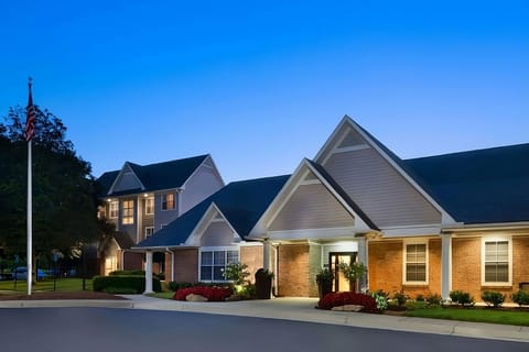 Come home at dusk to warm lights and landscaped grounds.
