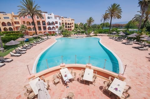 Dive into sun-soaked serenity beside this sweeping lagoon pool.