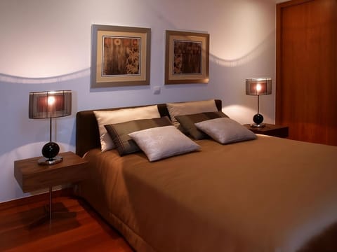 Unwind into plush pillows under warm, calming bedside light.