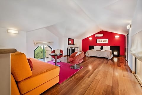 Unwind in the airy loft suite with warm wood floors.