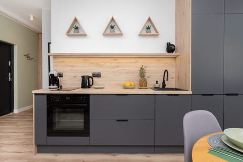 A wider perspective of the kitchen, highlighting its contemporary design and practicality.