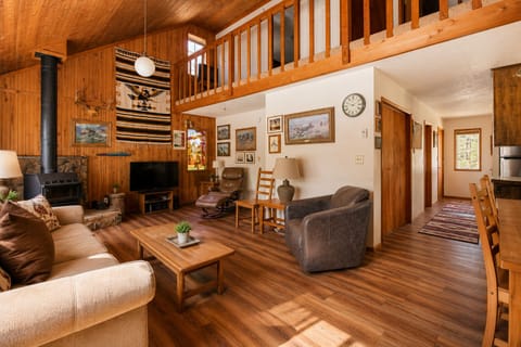 Unwind in your spacious living room with vaulted wood ceilings, cozy fireplace, and a loft—perfect for gathering after a day of adventure.