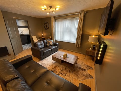 Open plan living area with flat screen TV and fireplace