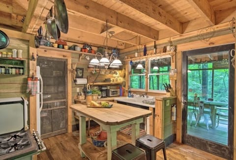 cozy kitchen is fully stocked with all you need to cook and serve a meal.