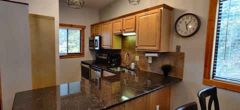 Kitchen is stocked with spices and small appliances.