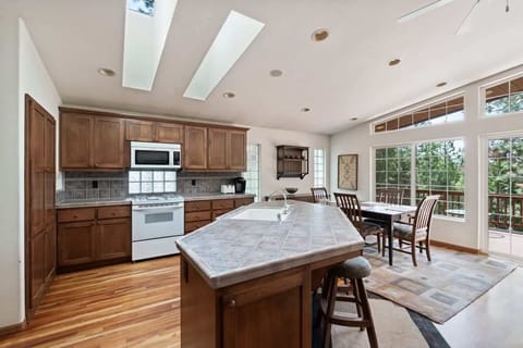 The spacious kitchen features a large kitchen island with 2 barstools, stainless steel appliances, and everything you need to cook a delicious meal for your group.