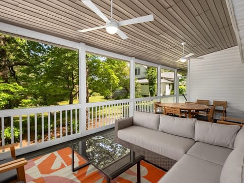 Embrace the serenity of trees and fresh air while relaxing on this porch.