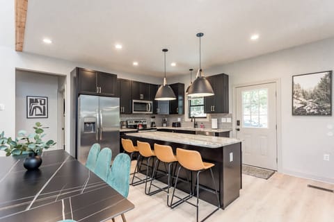 Stylish brand-new kitchen featuring granite countertops, tiled backsplash, new stainless appliances.