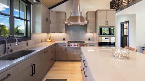 Chef's kitchen with built-in Wolf gas cooktop and Sub Zero fridge