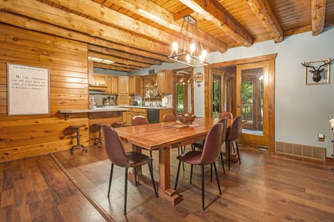 Dining room with seating for 8 at the table, and 3 at the bar.