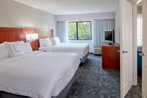 Drift off in crisp linens with a peaceful view outside.