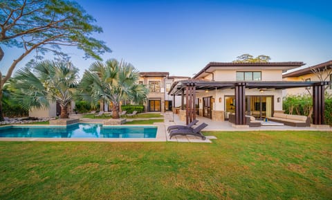 Experience upscale Costa Rica living at Hacienda Pinilla. This Avellanas Beach luxury home sits directly on the golf course, with lush landscaping and easy access to the sand, surf, and resort activities.