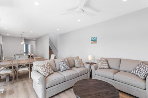 The open living area with a Smart TV and balcony access