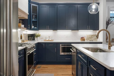 The kitchen has ample counter space, KitchenAid appliances, and a separate under counter ice maker.